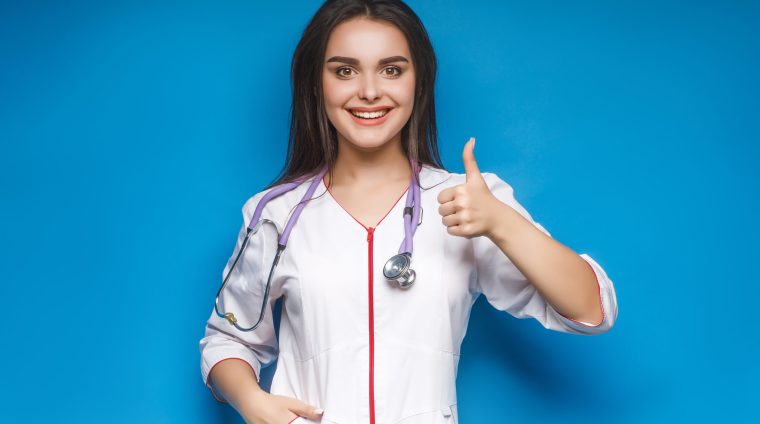 doctor 2 Gorgeous young female doctor make okaysign, over blue background. Young medidcine.