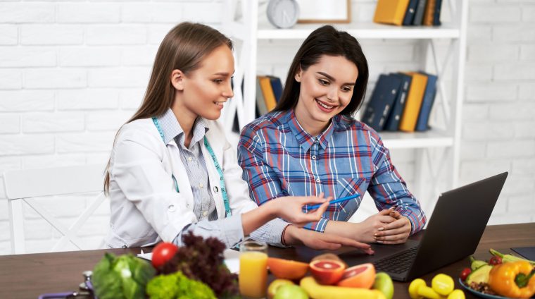 A smiling nutritionist advises a young patient woman on proper n online fellowship courses after mbbs, course for doctors, medical cert online,