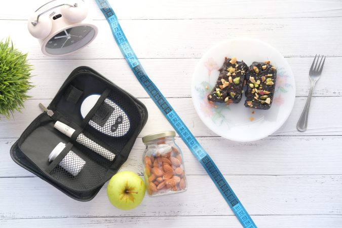 the concept of choosing healthy life style .diabetic measurement tools and browni on white