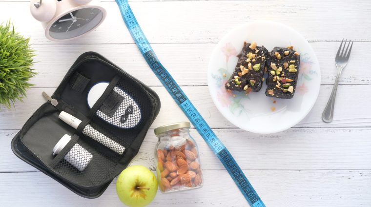 the concept of choosing healthy life style .diabetic measurement tools and browni on white